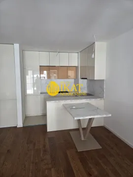 New kitchen with white cabinets and a dining table. - image 5