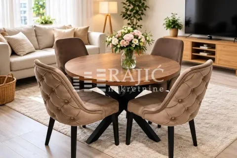 Living room with a dining table and chairs. - image 2