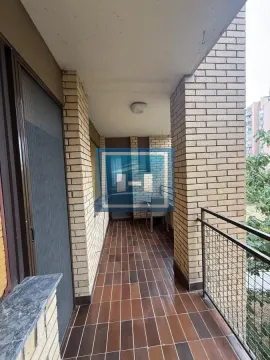 Covered balcony with tiled floor and brick and metal railing. - image 6