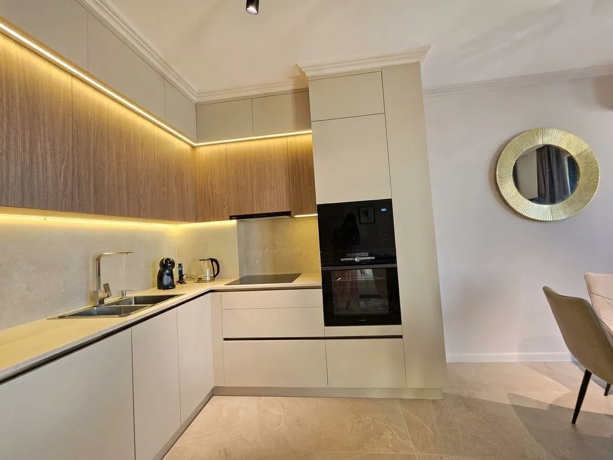 Modern kitchen with built-in appliances and LED lighting.