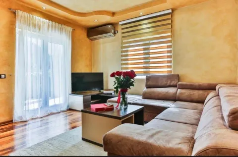 Living room with a sectional sofa, television, and access to the terrace. - image 13