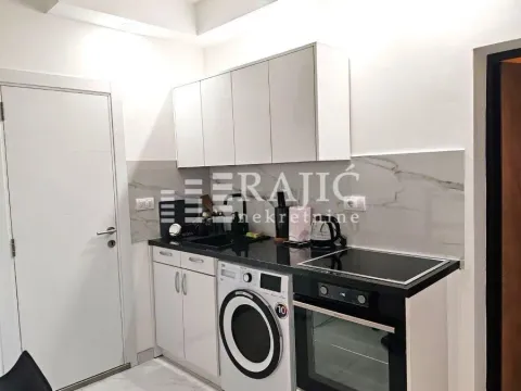 Smaller modern kitchen with white cabinets and built-in appliances. - image 7