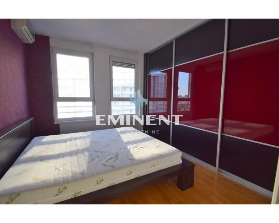 Bedroom with a double bed and a fitted wardrobe.