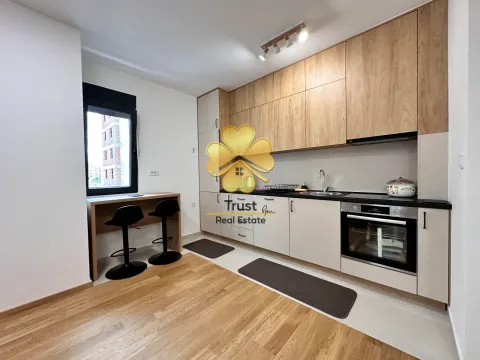Modern kitchen with wooden elements and a dining bar. - image 4