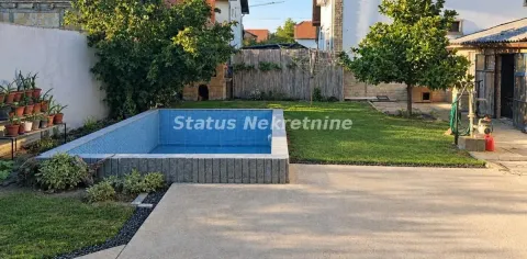 Dvorište kuće sa bazenom, uređenim travnjakom i zelenilom. - image 18