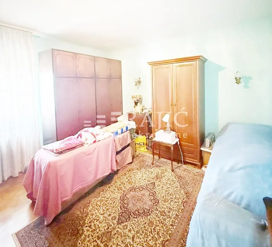 Furnished bedroom with wardrobes and a bed.