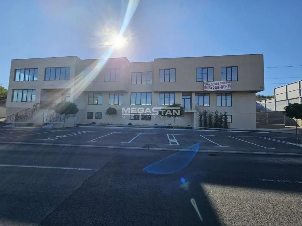 Exterior view of the office building with a parking lot.