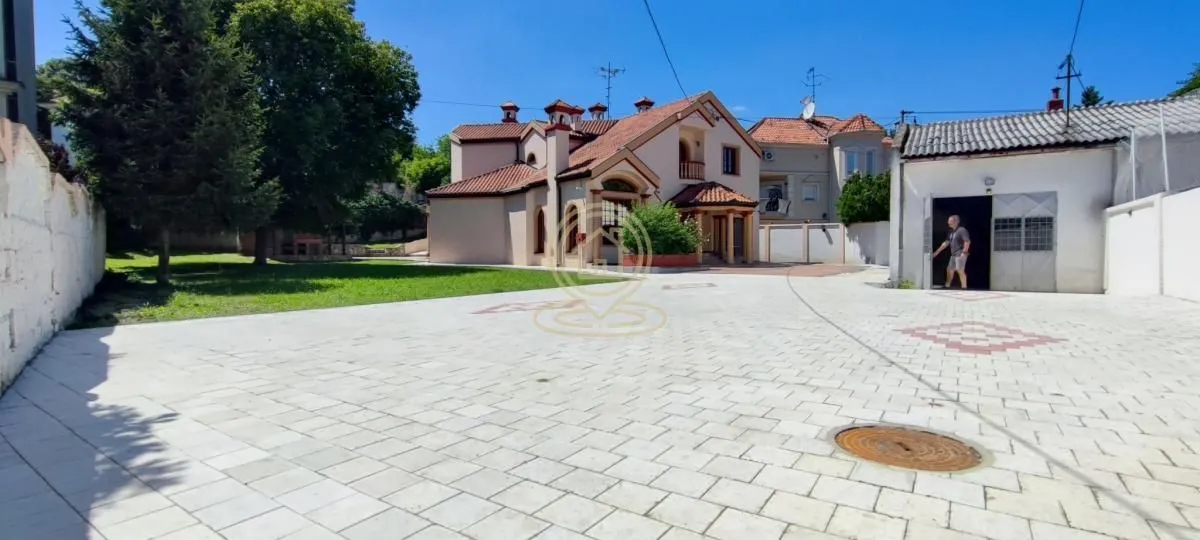 View of the courtyard and exterior of the house with a paved patio.