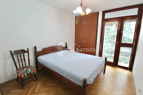 Spavaća soba sa bračnim krevetom, drvenim ormarom i balkonskim vratima. - image 7