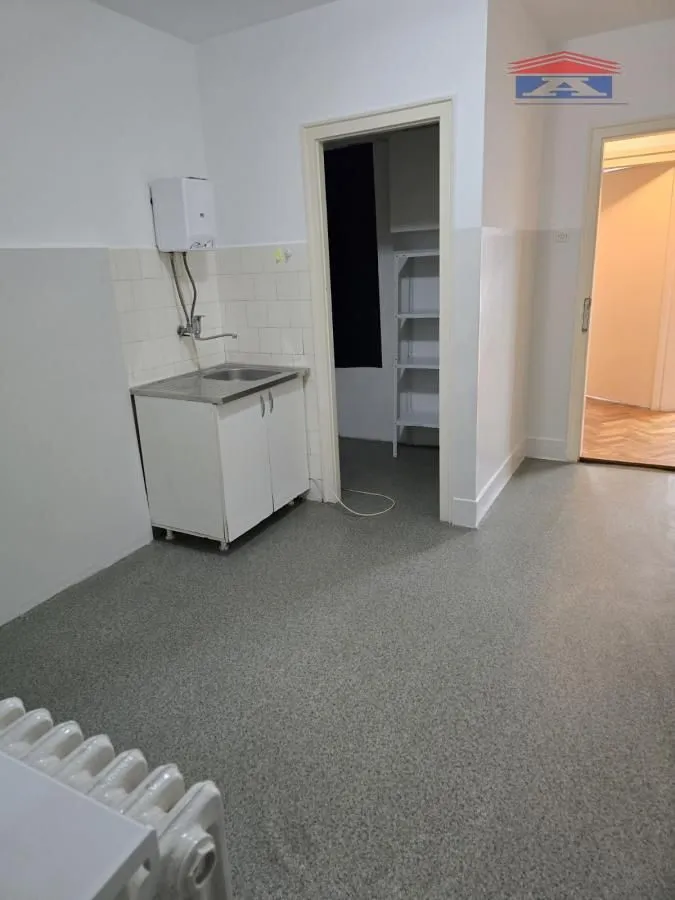 Smaller kitchen with a sink and a base cabinet.