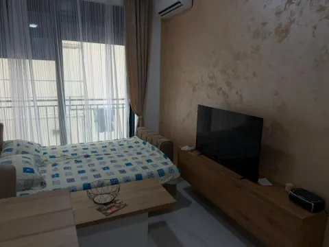 Furnished bedroom with a double bed, TV, and access to the terrace. - image 10