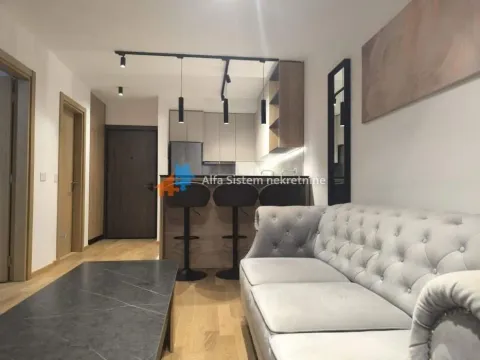 Living room with a sofa and a view towards the kitchen with a breakfast bar. - image 14