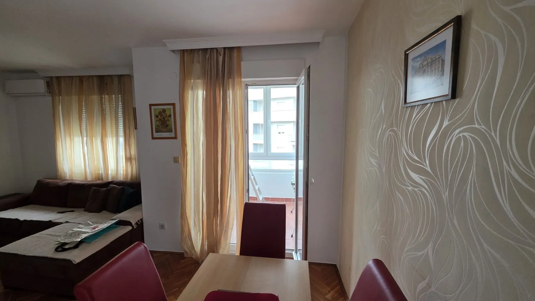 Living room with dining area and balcony access.
