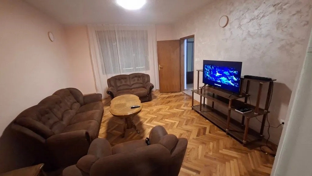 Living room with a seating set, coffee table, and TV.