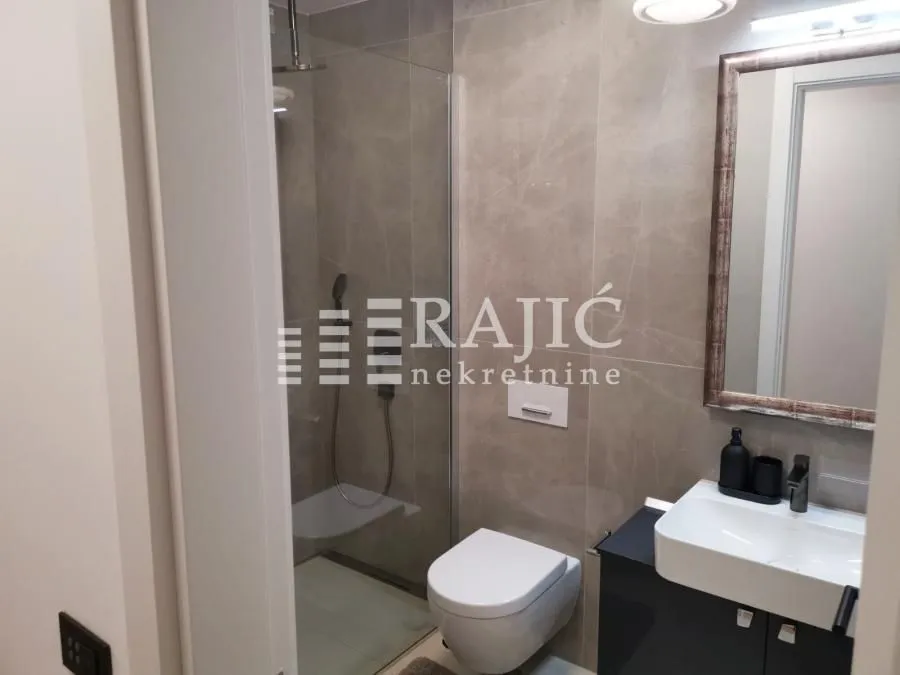 Modern bathroom with a shower cabin and a sink.
