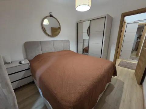 Furnished bedroom with a double bed, wardrobe, and mirror. - image 16