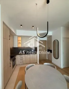 Modern kitchen with a dining area and built-in appliances. - image 4