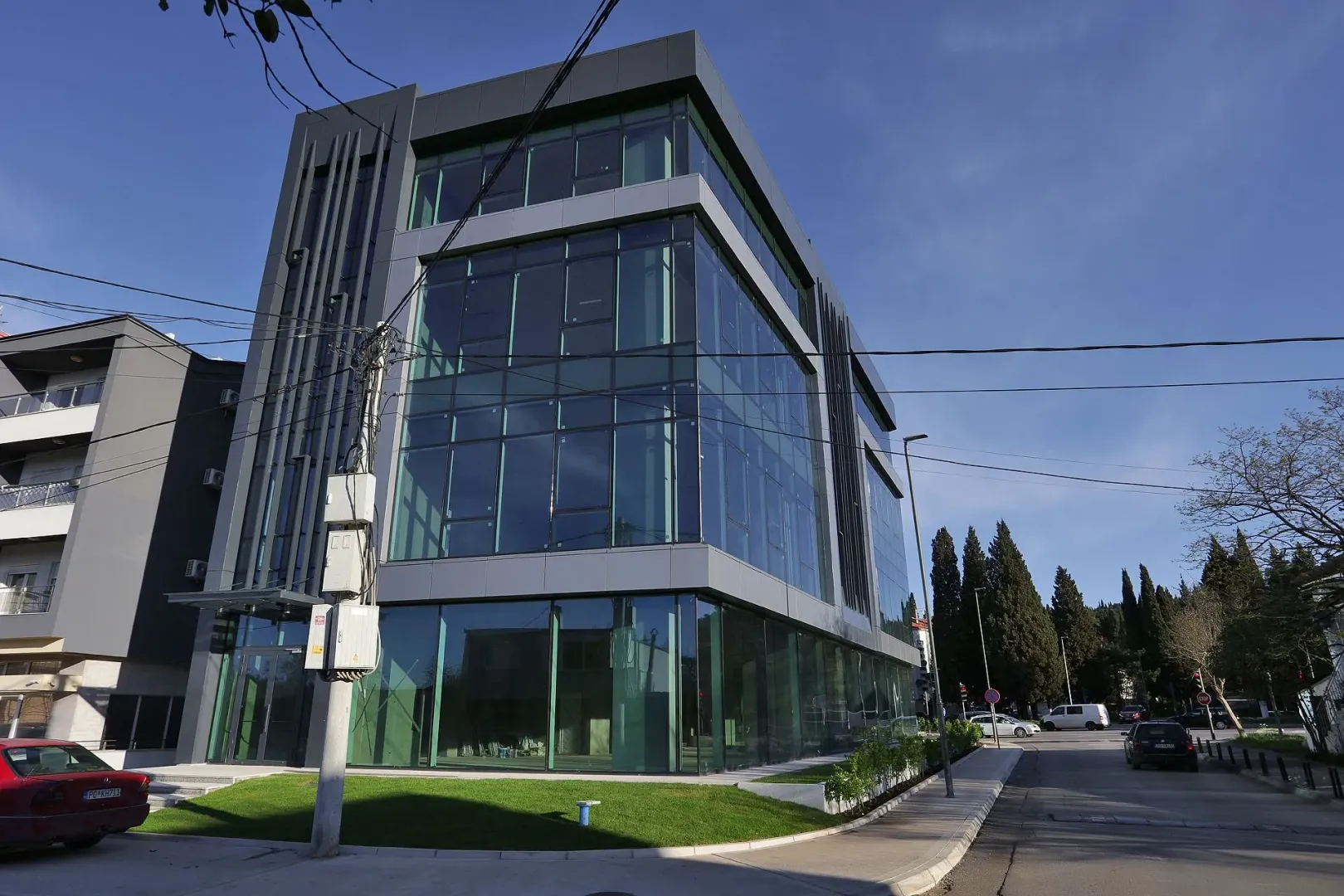 Modern office building with a glass facade next to the street.