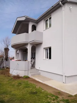 Exterior view of a two-story house with a yard and balcony. - image 7