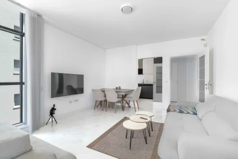 Bright living room with a sofa set, dining area, and access to the terrace. - image 9