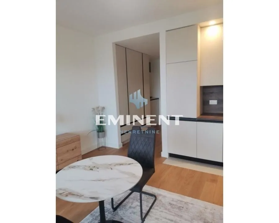 Modern kitchen with built-in cabinetry and a dining table.