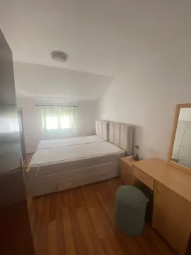 Bedroom with a double bed, wooden flooring, and a dressing table with a mirror. - image 7