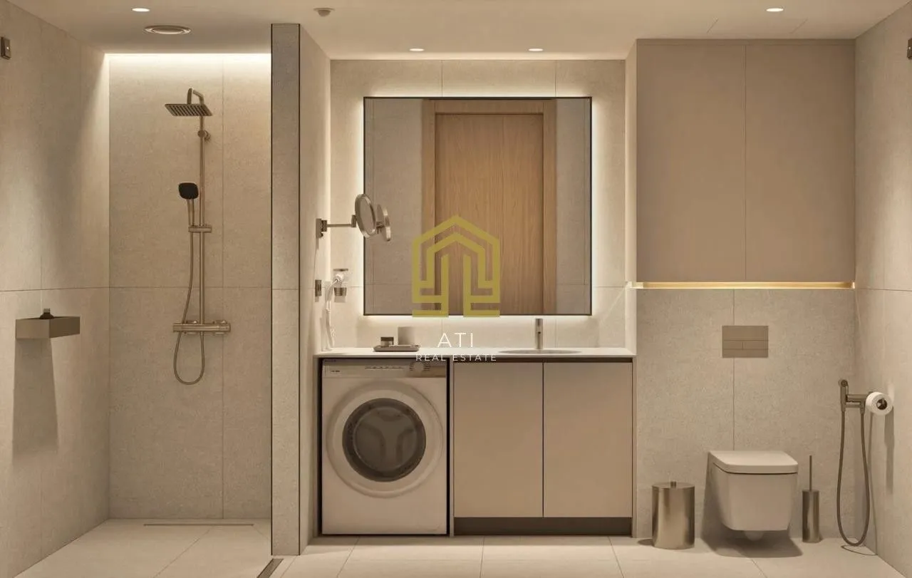 Moderne opremljeno kupatilo sa tuš kabinom, umivaonikom i veš mašinom.