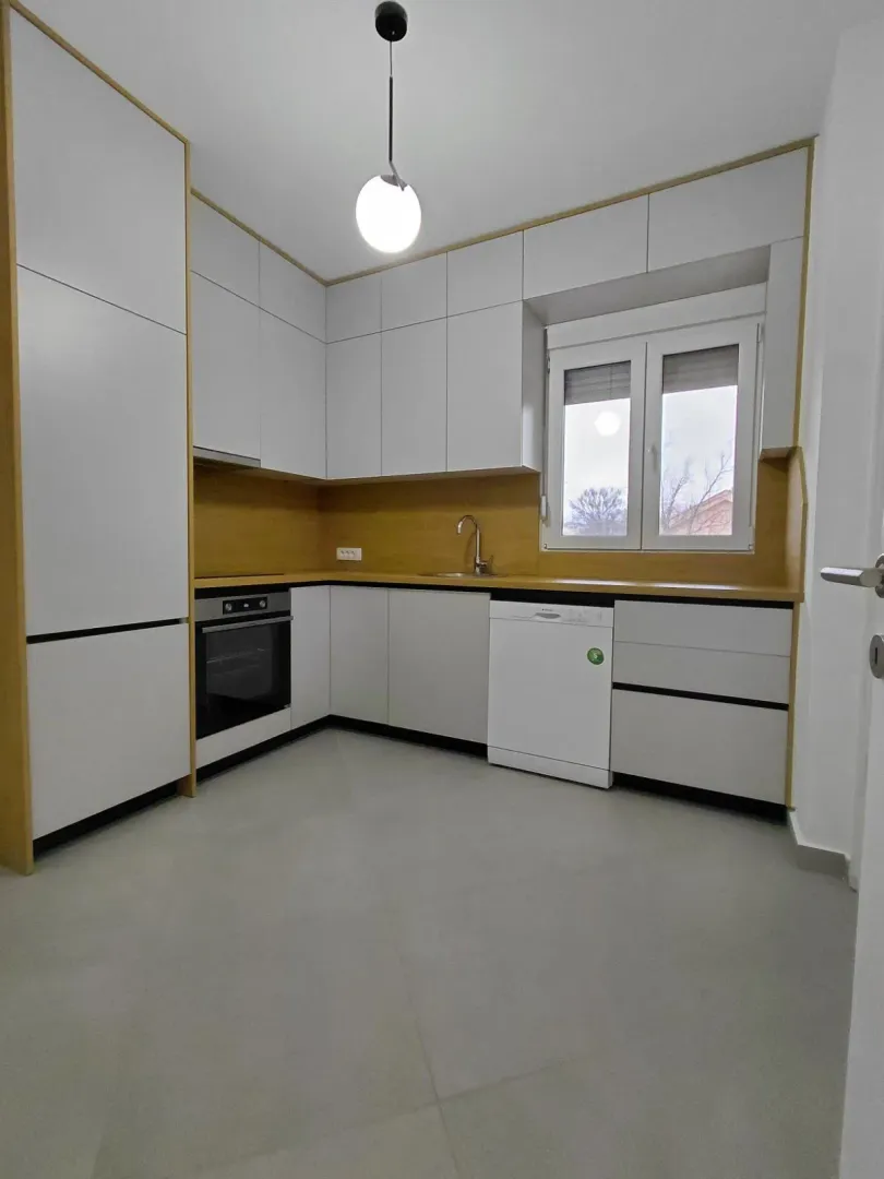 Modern kitchen with built-in cabinetry and white goods.