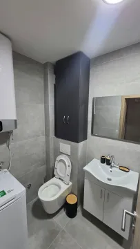 Modern equipped bathroom with a shower cabin, sink, and sanitary facilities. - image 7
