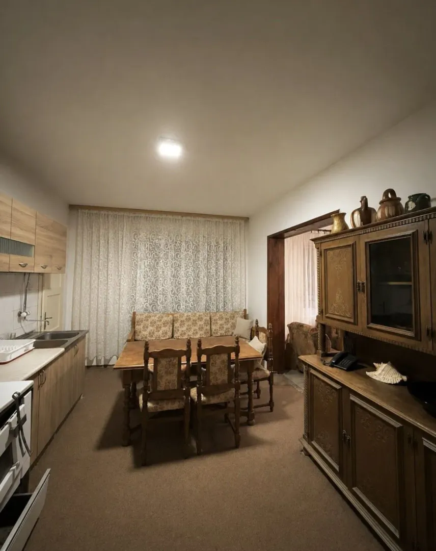 Kitchen and dining area with wooden furniture.
