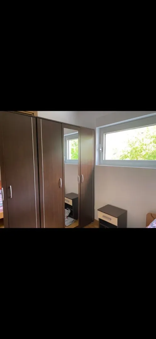 Bedroom with wardrobe and a window.