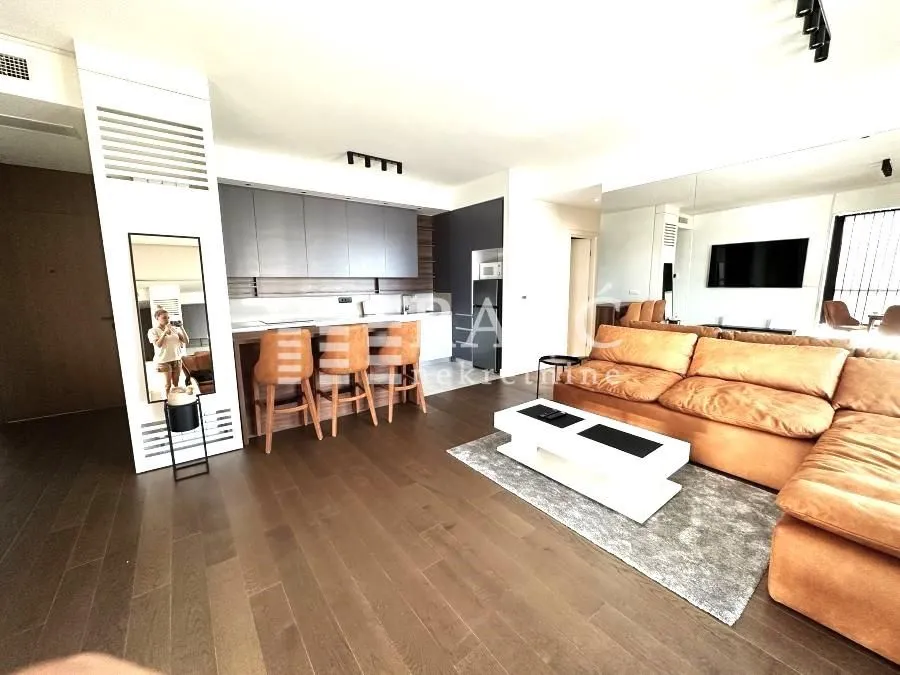 Living room with a sofa and dining area.