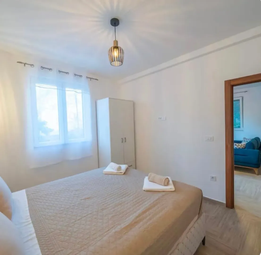 Bright bedroom with a double bed and wardrobe.
