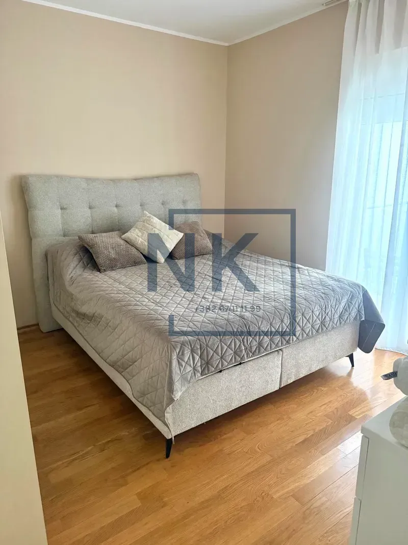 Bedroom with a double bed and wooden flooring.