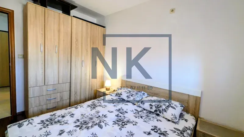 Bedroom with a double bed and wooden wardrobe.