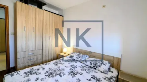 Bedroom with a double bed and wooden wardrobe. - image 9
