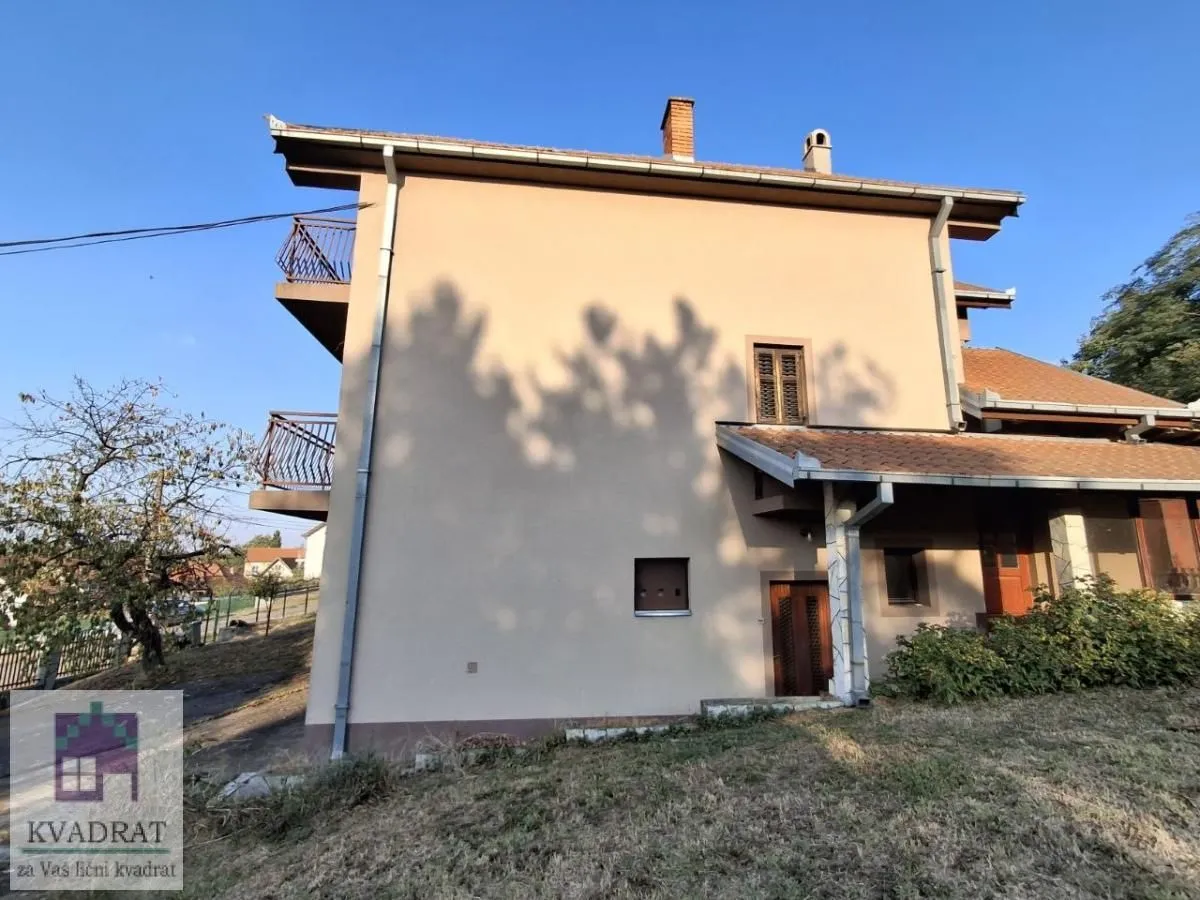 Bočni pogled na spoljašnjost kuće sa dvorištem i terasama.
