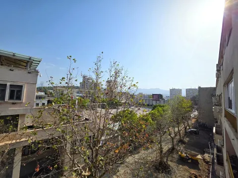 View of surrounding buildings and trees from a terrace or window. - image 8