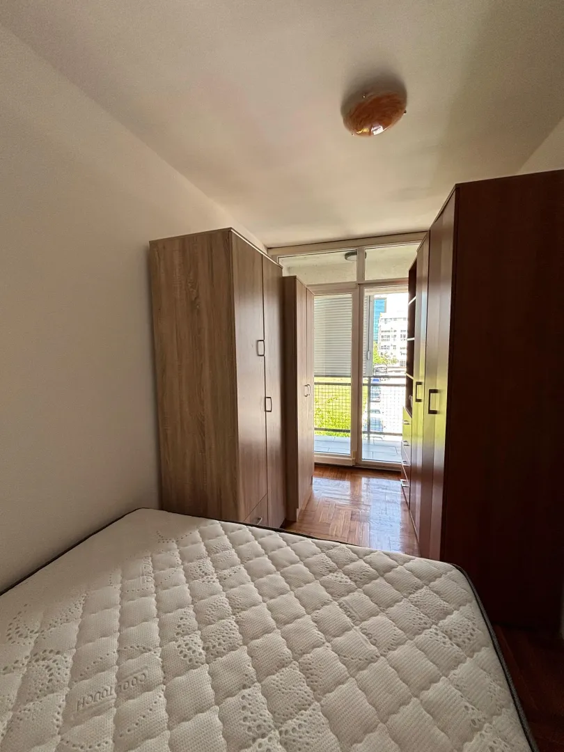 Bedroom with a bed, wardrobes, and access to the terrace.