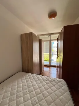 Bedroom with a bed, wardrobes, and access to the terrace. - image 12