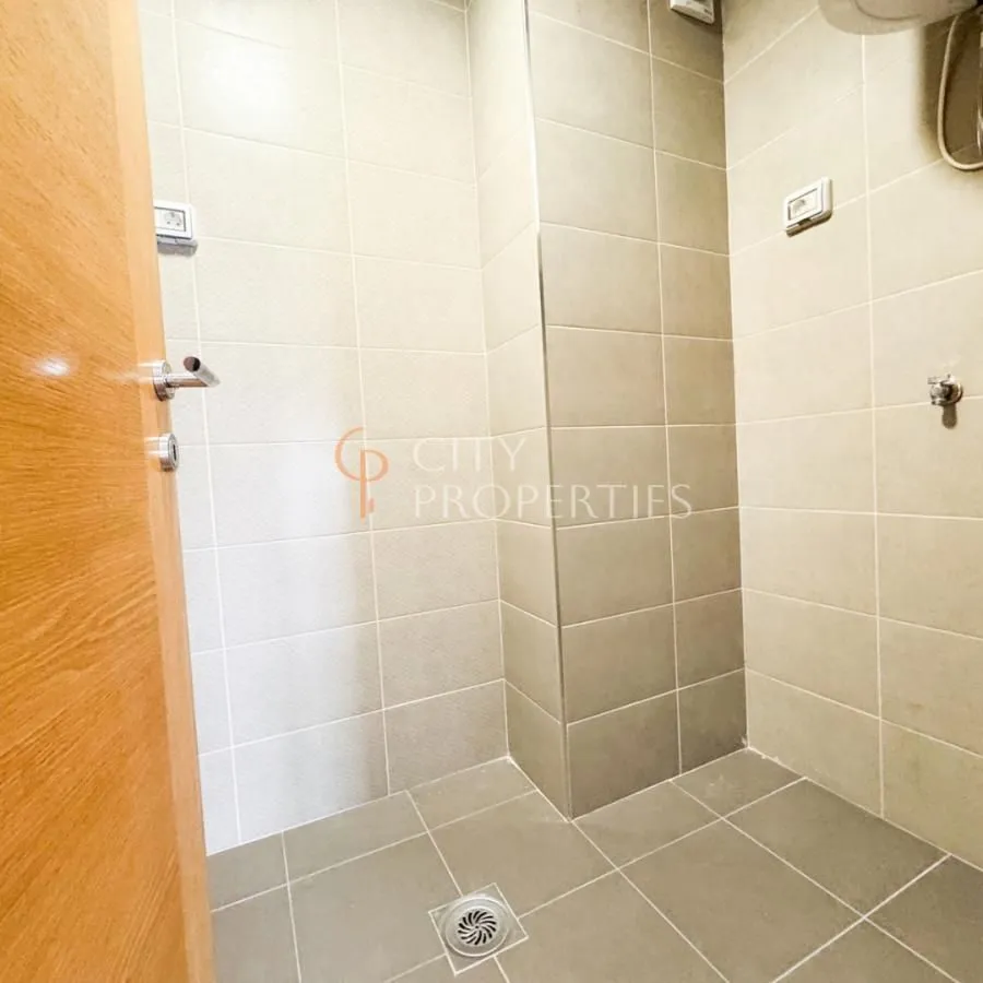 View of a tiled bathroom with a shower area.
