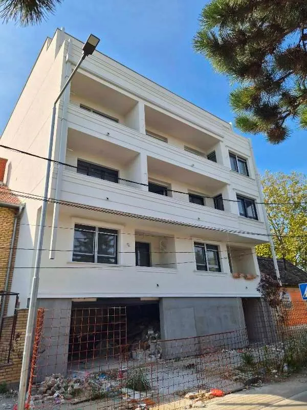 Exterior view of a new residential building with terraces.