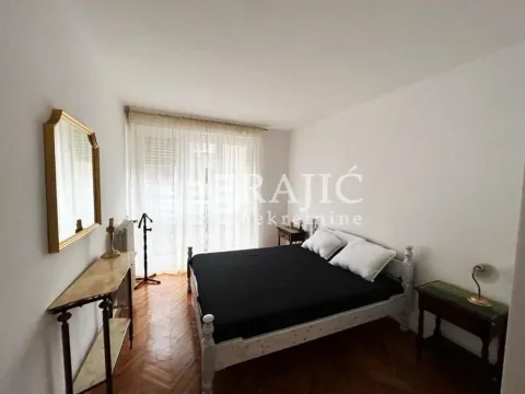 Bedroom with a double bed, mirror, and table. - image 16