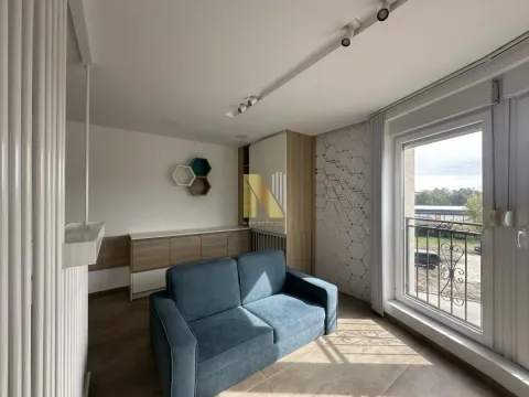 Smaller furnished living room with a sofa and balcony access. - image 3