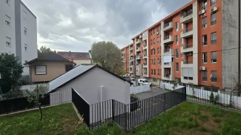 Backyard view of the residential building and surrounding structures. - image 8