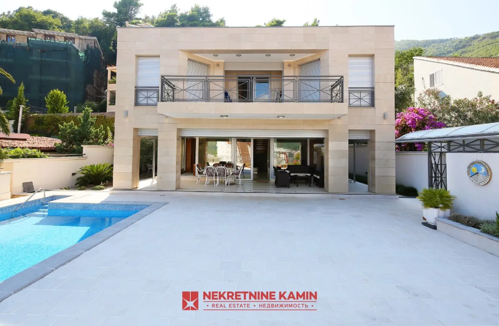 View of the exterior of the house with a swimming pool and yard.
