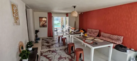 Spacious living room with a dining table and terrace access. - image 33