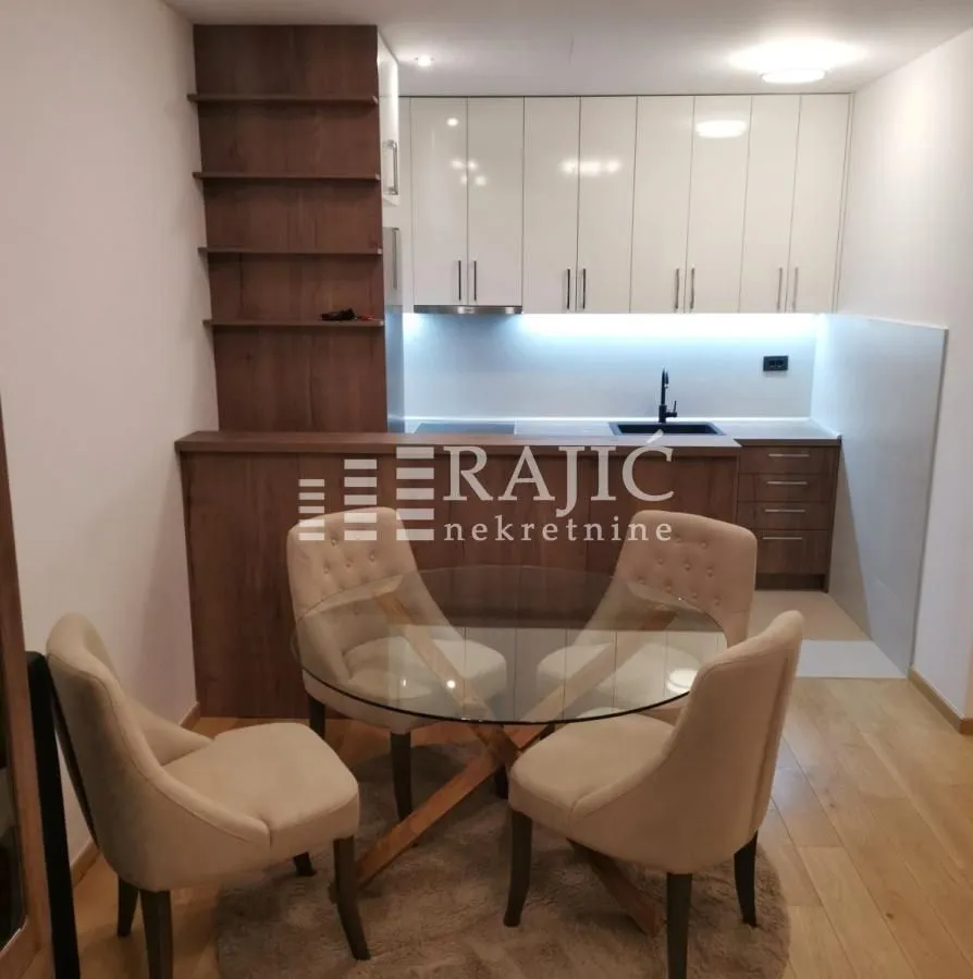 Modern kitchen with a dining table and chairs.