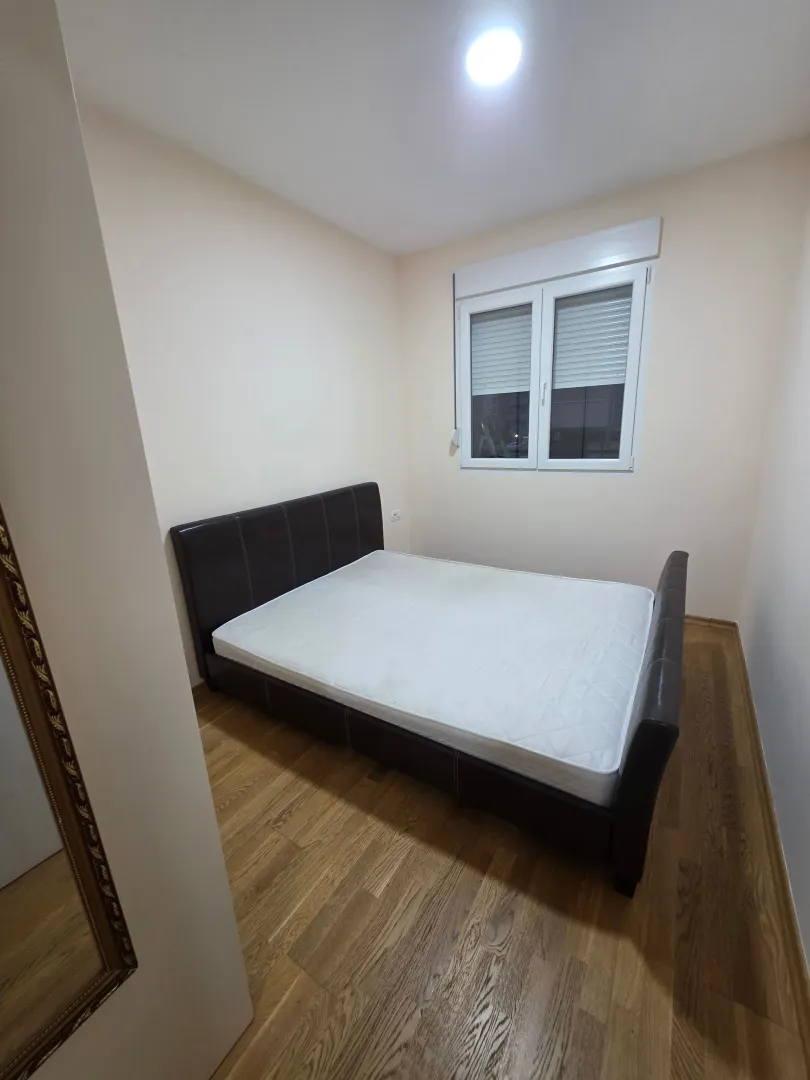 Bedroom with a double bed and a window.