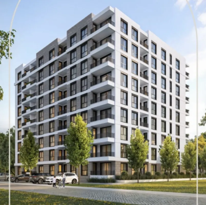 Exterior view of a modern residential building with balconies and landscaped courtyard.